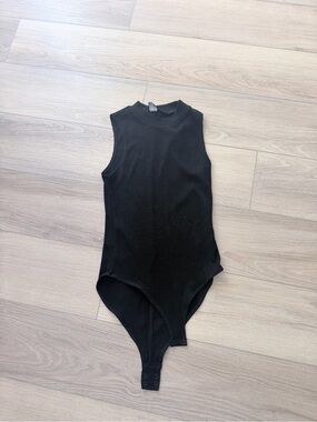 Sleeveless Black Ribbed Mock-Neck Bodysuit